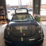 Porsche convertible in repair shop